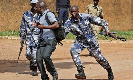 Police arrest a journalist outside the Daily Monitor offices, in Kampala.