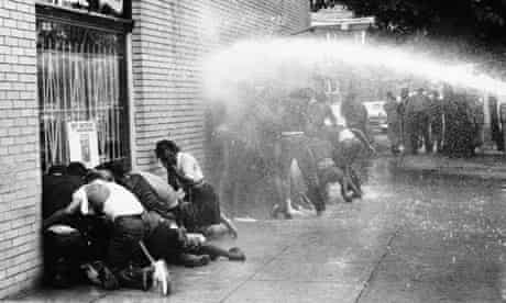Civil rights protestors are attacked with a water cannon.