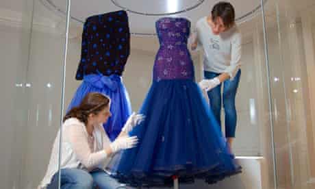 Conservators wprk on a blue dress Murray Arbeid dress worn by Princess Diana