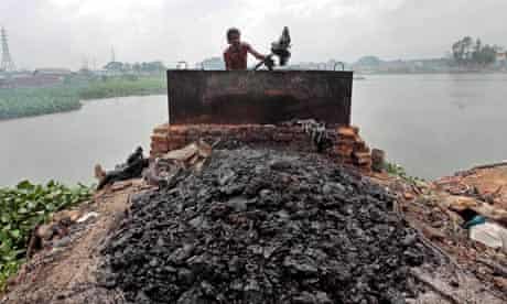 Bangladeshi man scoops out tannery waste 