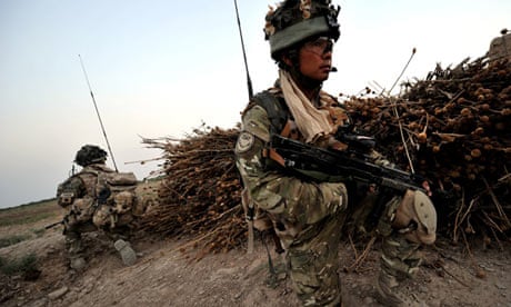 Soldiers from the Royal Gurkha Rifles crouching on patrol in Helmand province
