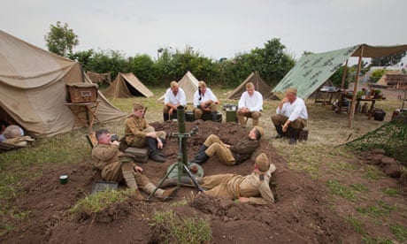 Re-enactors in Russian second world war uniforms, surrounded by tents
