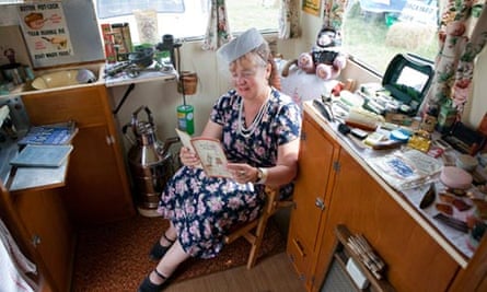 Karen Poole sitting in her caravan museum surrounded by 1940s paraphernalia