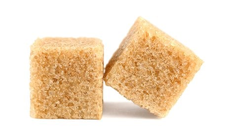 Cubes of cane sugar isolated on white background