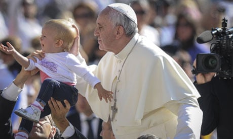 The pope blesses a child in St Peter's Square, Vatican City.