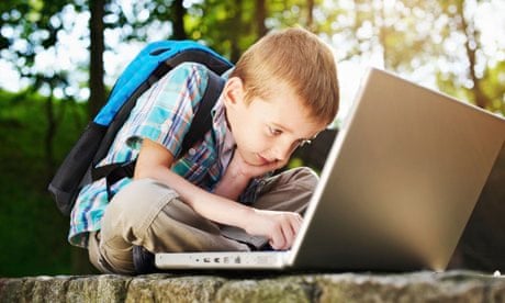 A young boy on a laptop.