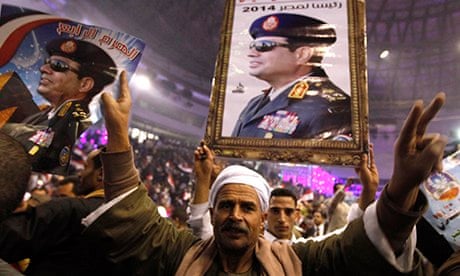 Supporters of Egypt's army chief Sisi hold posters during festivities in Cairo
