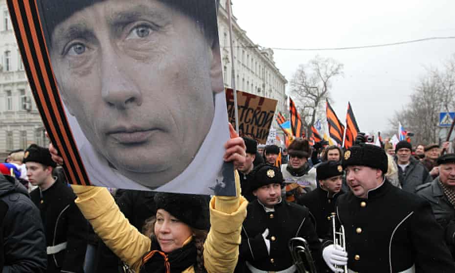 Russians attend a rally in Moscow to support Vladimir Putin with the invasion of Crimea
