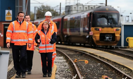 George Osborne and David Cameron in high-vis jackets with train in background