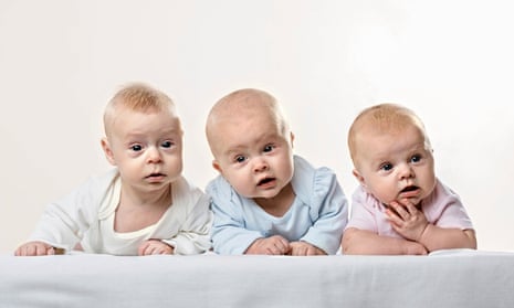Three babies in a row pulling funny faces