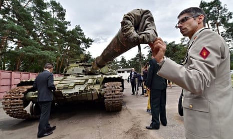 A military attache examines a Russian T-64BV tank seized in August during fighting in eastern Ukrain