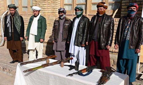 Former Taliban fighters hand over their weapons and join government forces in Herat province.