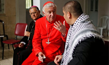 Vincent Nichols, the archbishop of Westminster, meets a priest at Der Latin church in Gaza City.