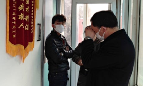 Friends of Chinese human rights activist Cao Shunli standing outside an intensive care unit