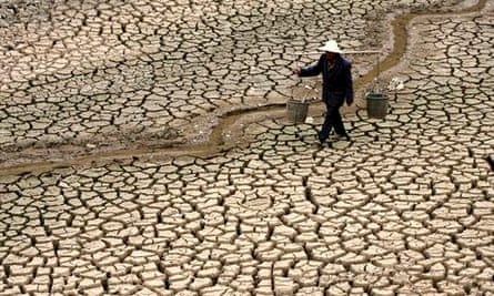 MDG : A Chinese farmer walks on a dry river bed in Yunnan province