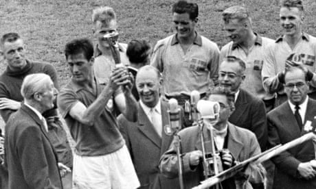 Bellini lifts the 1958 World Cup trophy with officials and Swedish players in the background