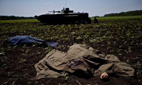 Bodies covered with blankets lie in a field near the village of Blahodatne, eastern Ukraine