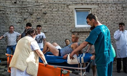 Ukrainian soldier wounded in the checkpoint attack is transferred to an ambulance in Volno