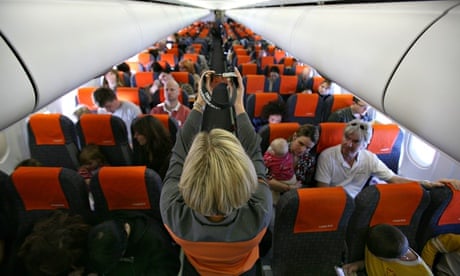 Easyjet flight attendant presents safety instructions to passengers
