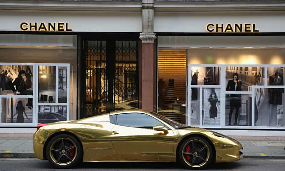 A gold Ferrari sits outside Chanel on Sloane Street, London