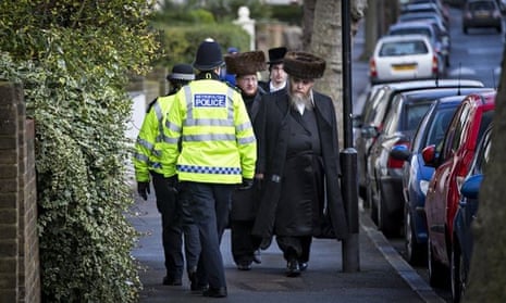 Policemen and Jewish men walking down the street