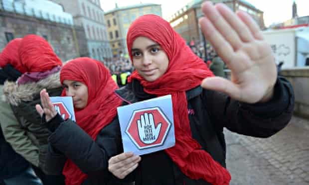 Girls bear leaflets reading: 'Don't touch my mosque' at a demonstration in Stockholm, Sweden
