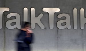 Man walks past company logo of TalkTalk