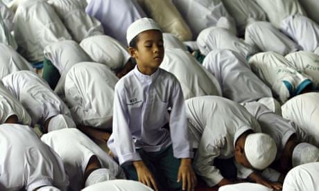 Muslim orphan praying during Ramadan, Thailand