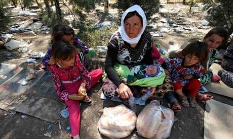 Yazidi woman and children resting, Syria border