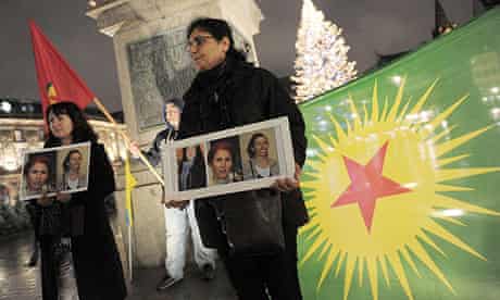 Kurds at a demonstration in Strasbourg hold photos of three Kurdish activists shot dead in Paris.