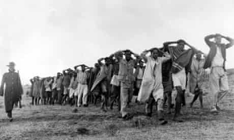 Mau Mau suspects being led away by police in Kenya's Rift Valley in 1952. 