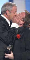 Scott Wittman, left, kisses Mark Shaiman as they accept the Tony award for best score for Hairspray