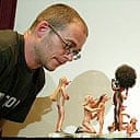 Dinos Chapman with some of the penis-nosed chess pieces