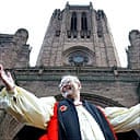 The dean of Liverpool Cathedral, Rev Rupert Hoare, celebrates its £83,000 grant from English Heritage