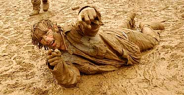 Glastonbury festivalgoer revels in the mud, 2004