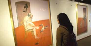 An Iranian woman looks at a Francis Bacon painting