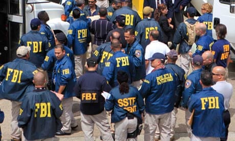 FBI agents wait to escort police officers