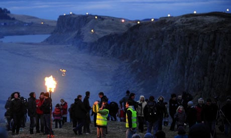 Volunteers carrying flaming torches light the route of Hadrian's Wall