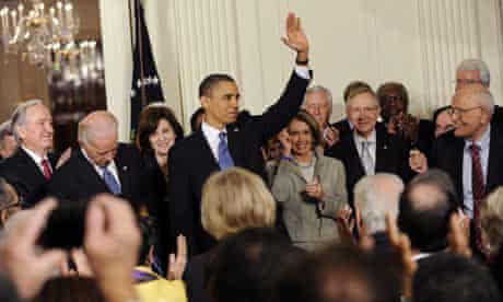 US President Barack Obama signs the health insurance reform bill in the East Room