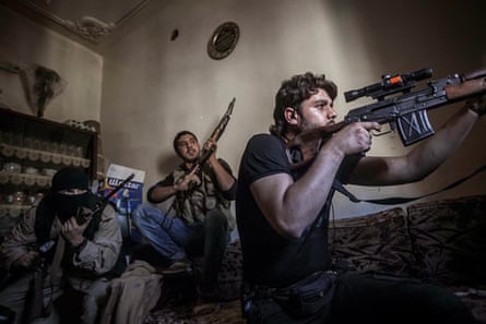 A rebel sniper aims at Syrian army positions in the Aleppo Jedida district
