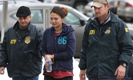 Dawn Nguyen is escorted into the Federal Building, Friday, Dec. 28, 2012, in Rochester, NY