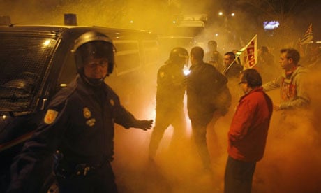 Police try to escort a truck leaving a food warehouse past picketers in Malaga, southern Spain