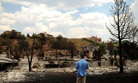 A secret service agent looks over homes in Colorado Springs burned by the Waldo Canyon fire