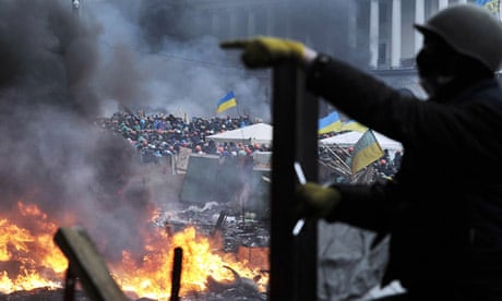 Protesters stand on barricades in Kiev