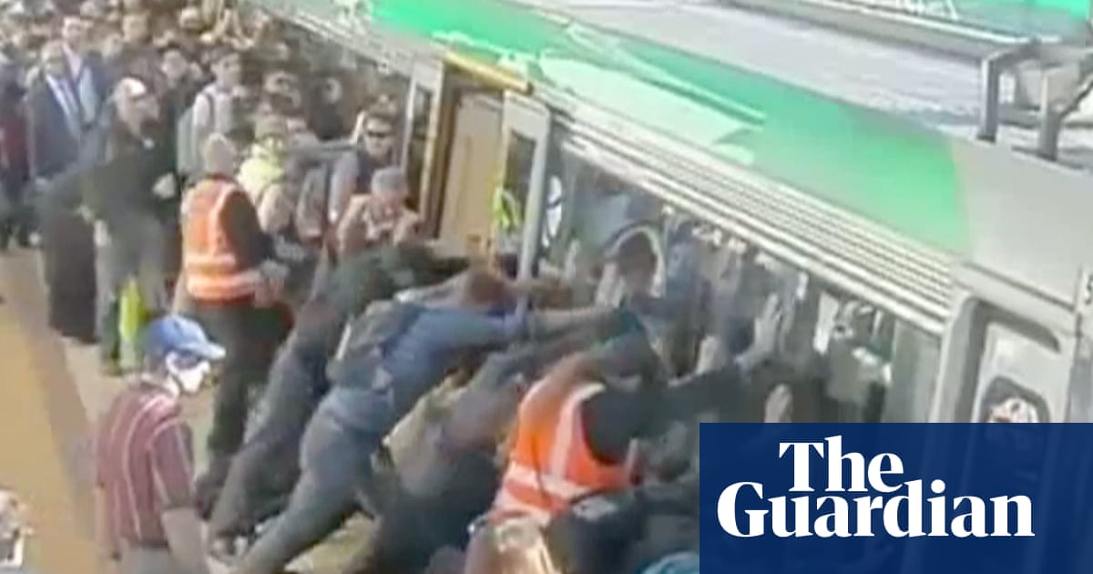 Perth commuters tilt train to free man - video