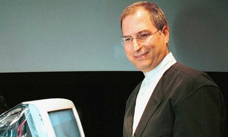 Apple Computer interim CEO and co-founder Steve Jobs poses next to new iMac after introduction 1999
