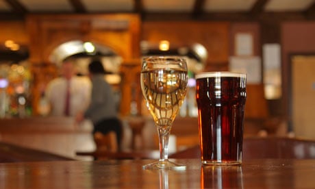 Close up of a glass of wine and pint of beer