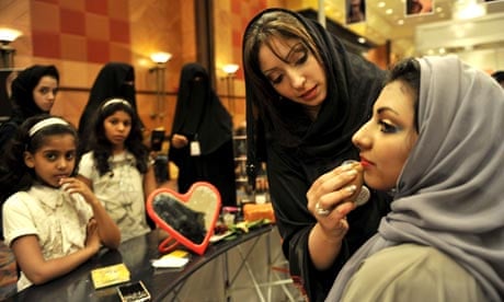 A Saudi woman applies makeup