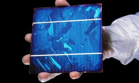A hand holding a solar panel