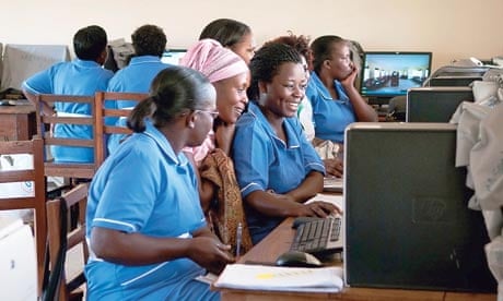 Students crowd around computers in the e-learning centre at Masaka school of comprehensive nursing